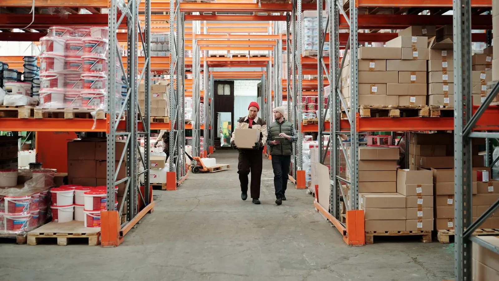 Workers walking along an aisle in a warehouse